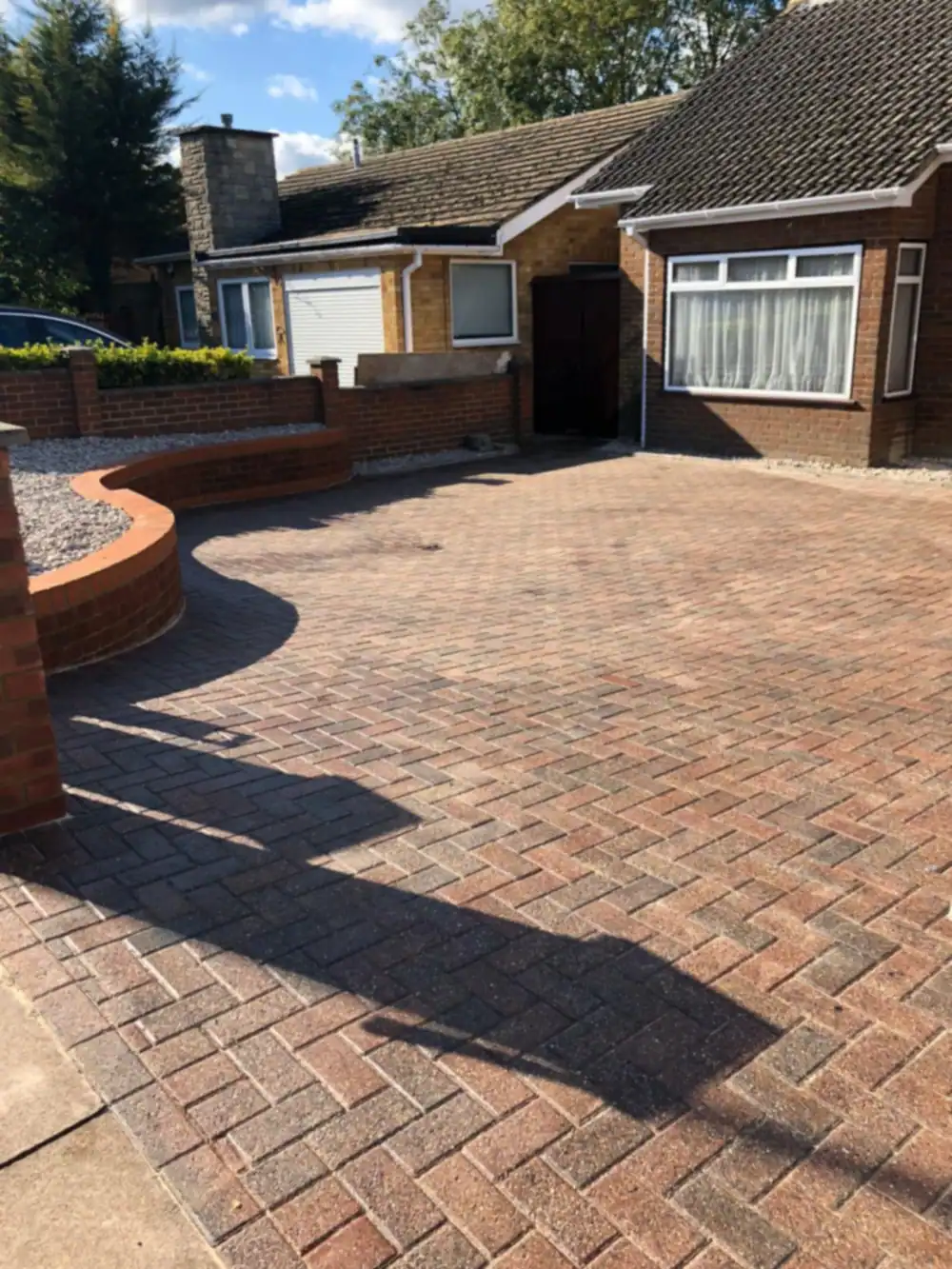 Builders in Luton: new block paved driveway in front of a bungalow