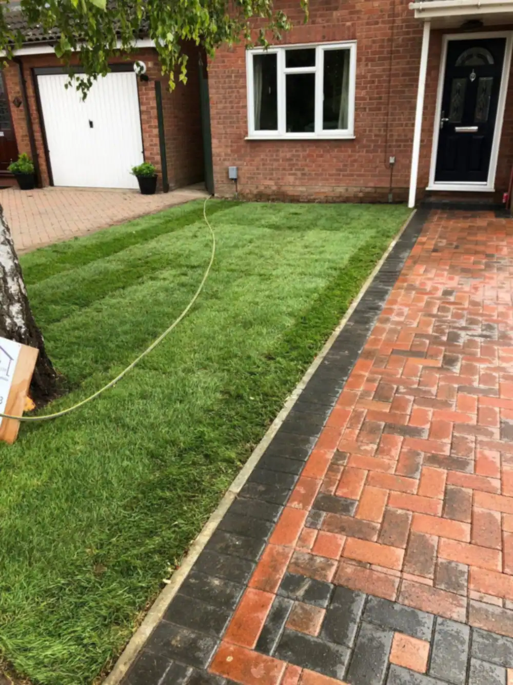 New block paved path beside a fresh lawn