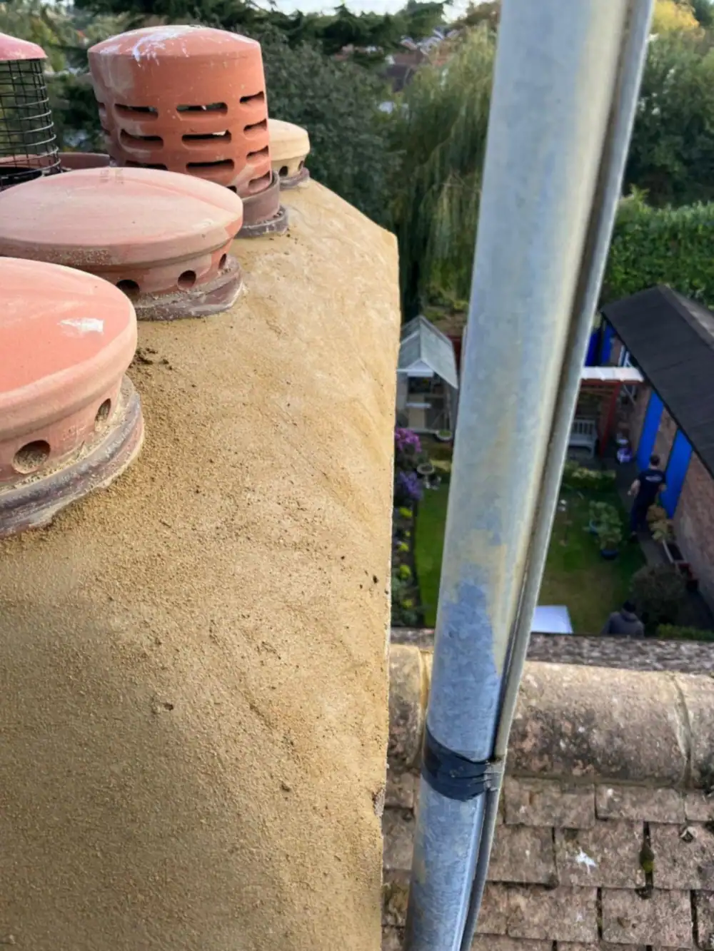 Chimney with new flaunching and pots, scaffold alongside