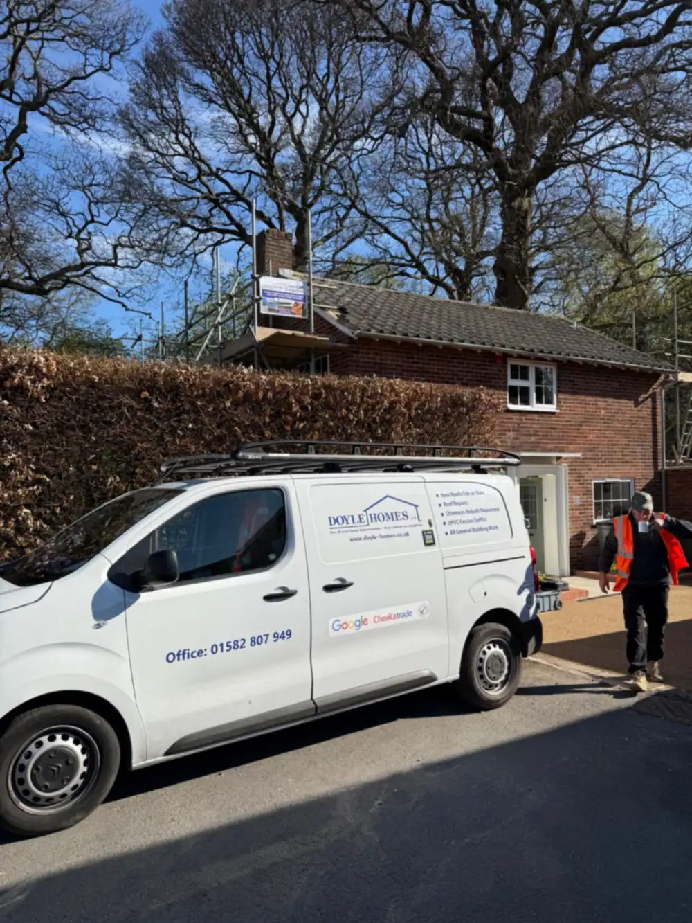Doyle Homes van with the 01582 office number at a scaffolded roofing job