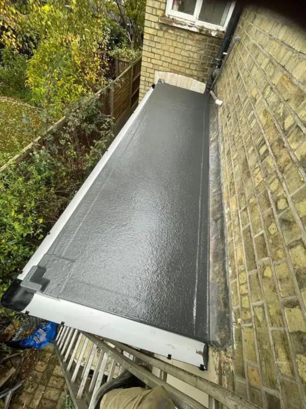 Fibreglass flat roof on a narrow side extension, finished with a clean edge