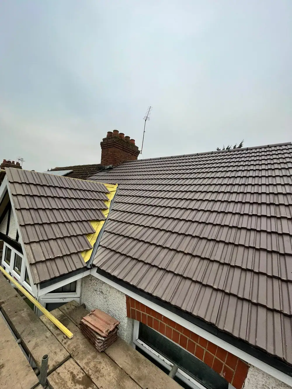 Tiled re-roof: finished brown tile roof with a neat valley beside a dormer