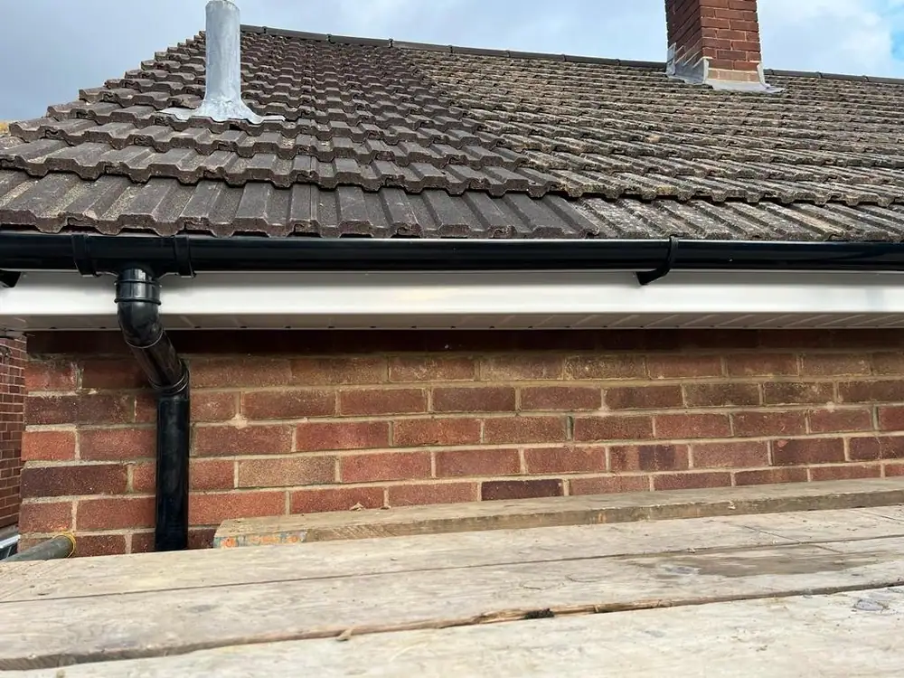 Concrete tile roof with new black guttering, typical of a Milton Keynes estate re-roof
