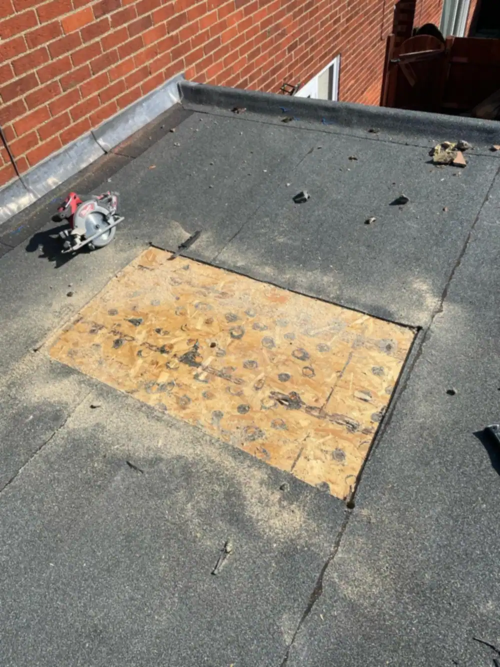 Flat roof patch repair with new OSB