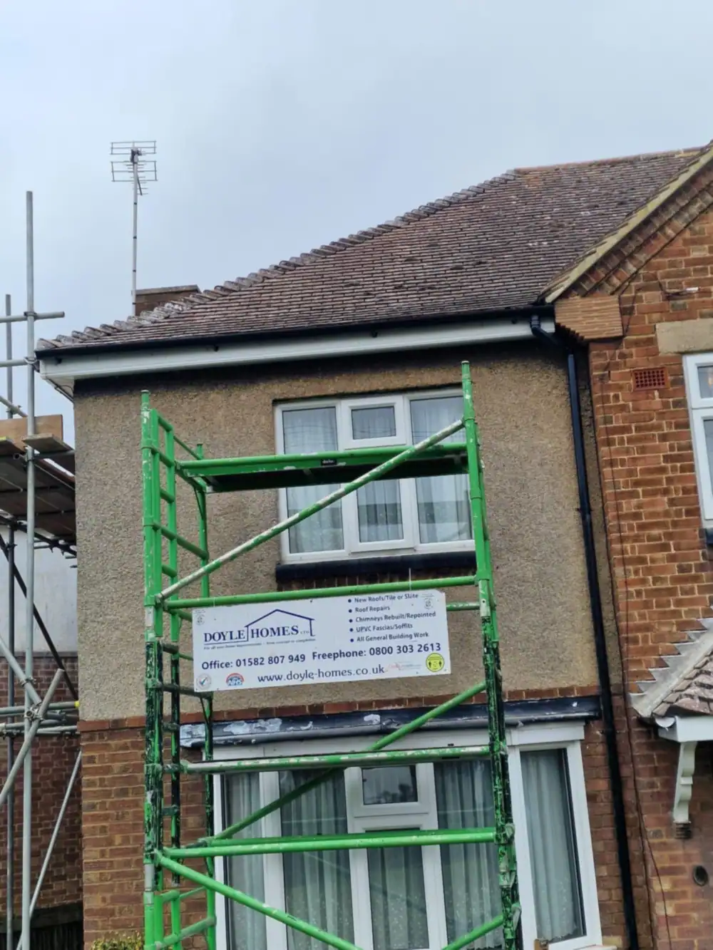 House with scaffold tower and Doyle Homes sign