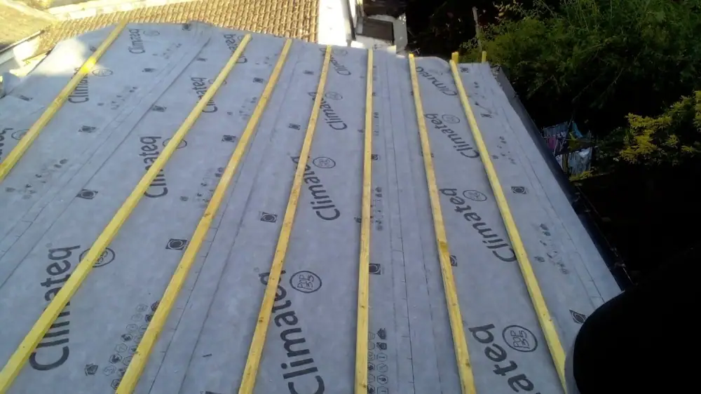 Roof replacement: breathable roof membrane laid with new yellow battens across a pitched roof