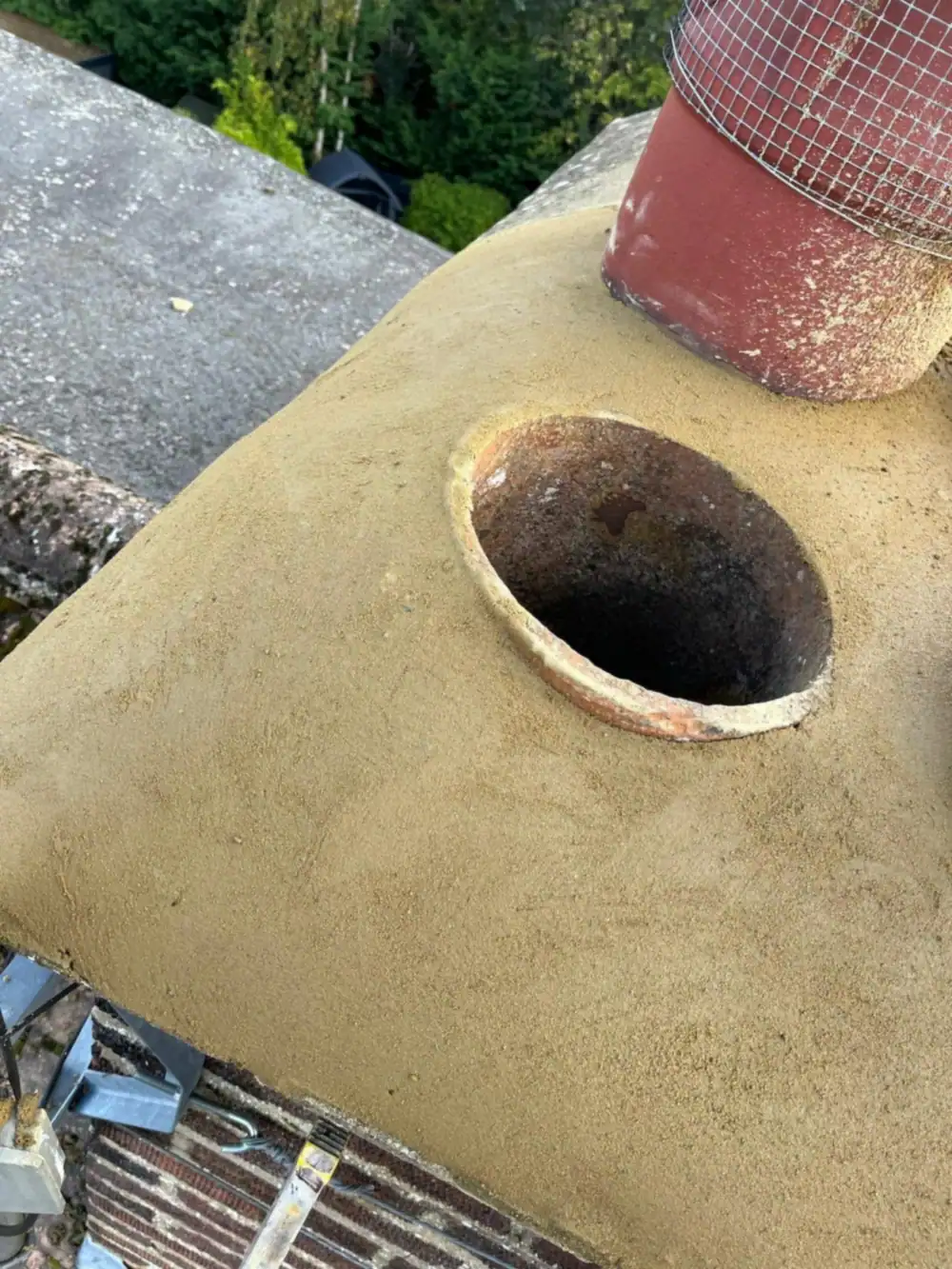 New mortar flaunching around a chimney pot after chimney repair