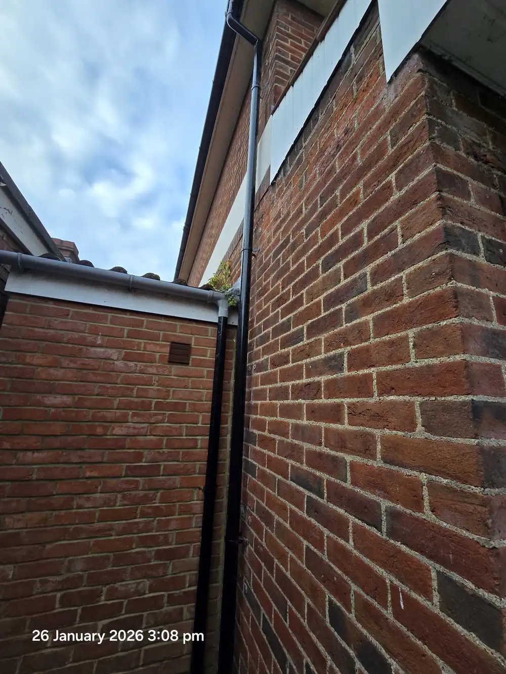 New downpipe on a brick corner