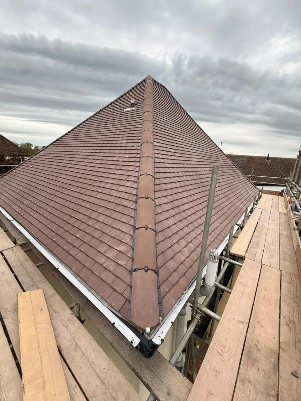 Watford roofing: new hip ridge on a finished tiled roof from the scaffold