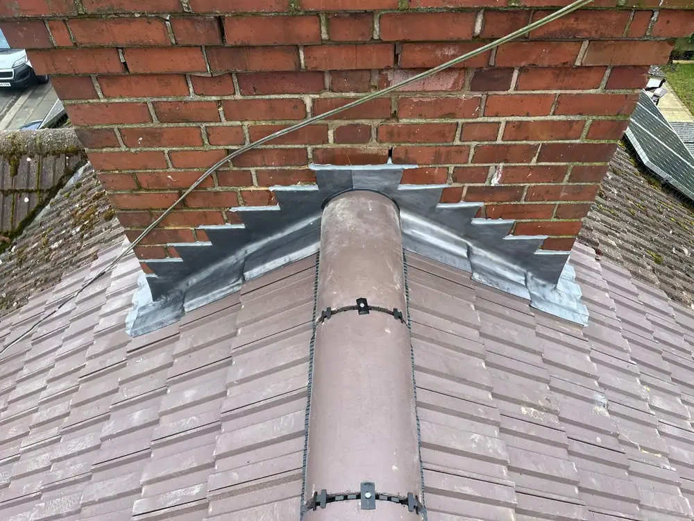 Lead apron and new ridge at a chimney, an example of lead roofing detail
