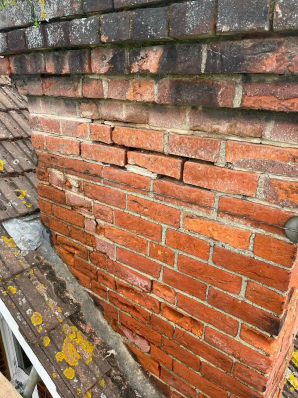 Chimney repair needed: weathered brickwork close-up before repointing