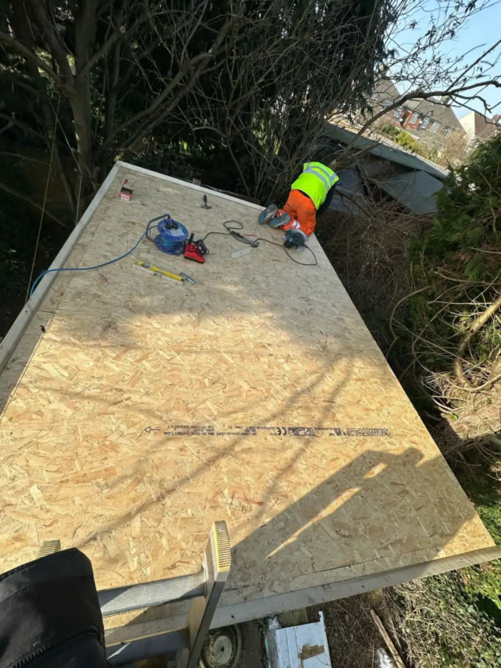 OSB flat roof deck with a worker in hi-vis