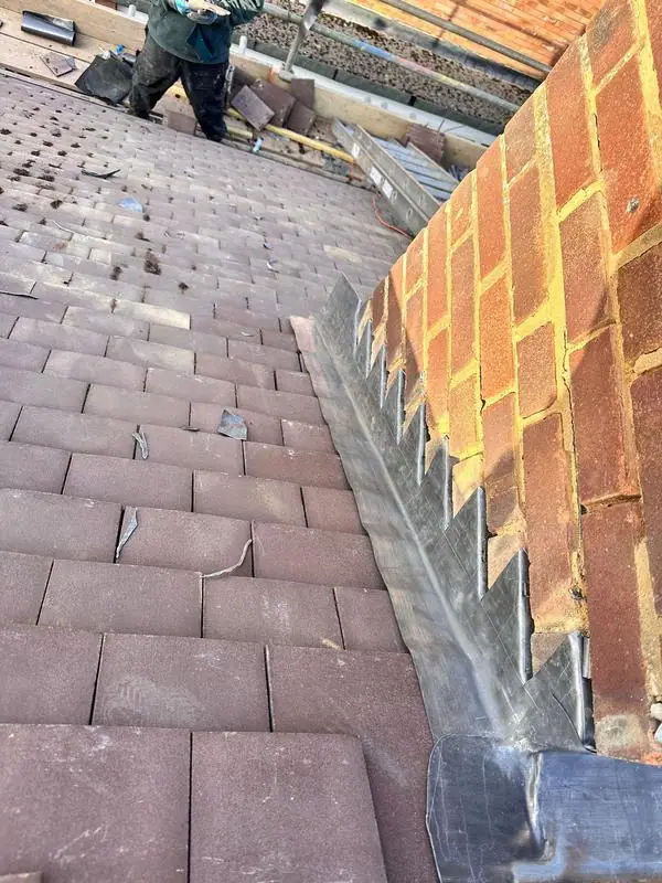 Plain tile roof with new stepped lead at the abutment