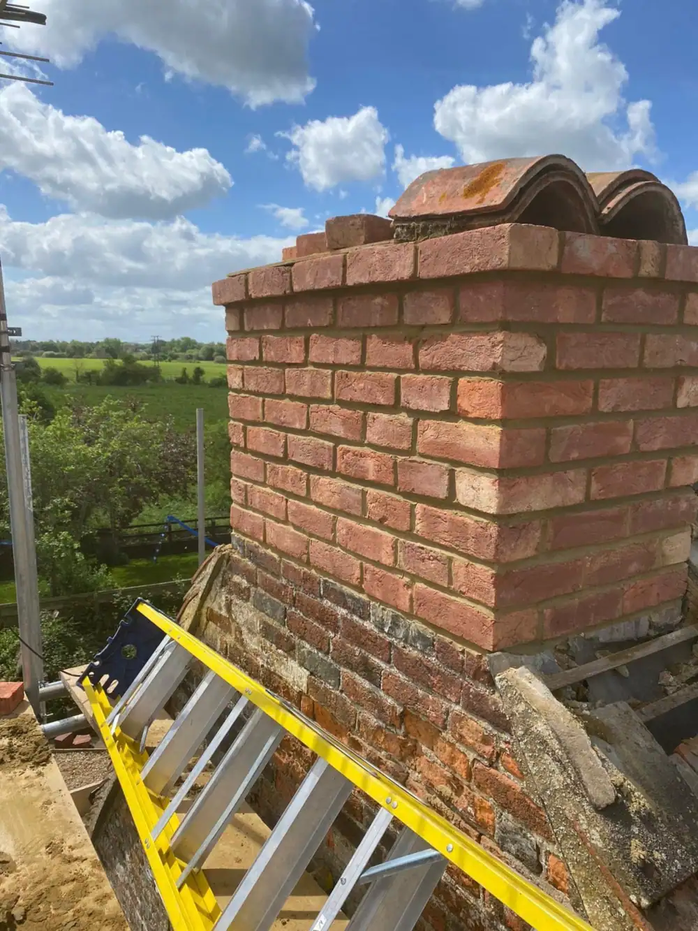 Chimney repair finished: a rebuilt brick chimney stack with new pots