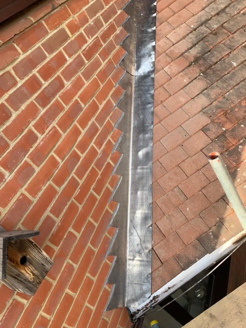 Lead roofing detail: new stepped lead flashing fitted to a brick wall