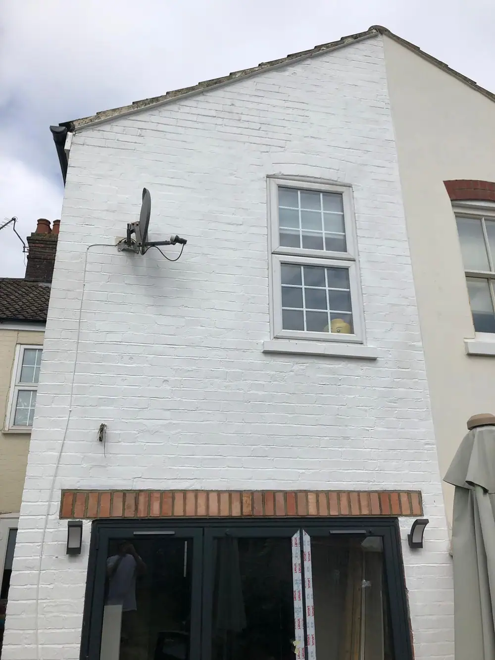Rear of a house with freshly painted white brickwork